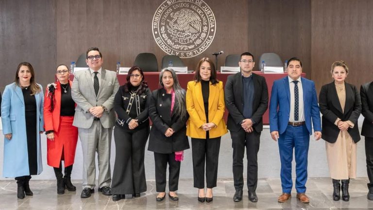Tribunal Superior de Justicia de Tlaxcala, jueces y magistrados en una sesión con fondo de madera y logo oficial en la pared.