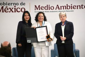 Reconocimiento de premiación en medio ambiente con tres mujeres en un evento oficial en Tlaxcala, México.